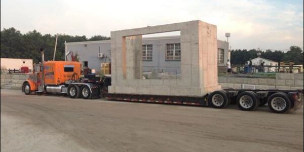 Oversized freight being moved via our lowboy service.