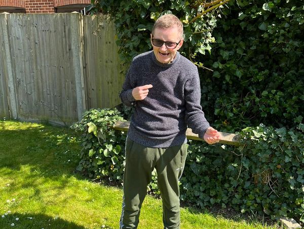 Elderly man from Nirvana Adult Day Care Centre in the park enjoying himself