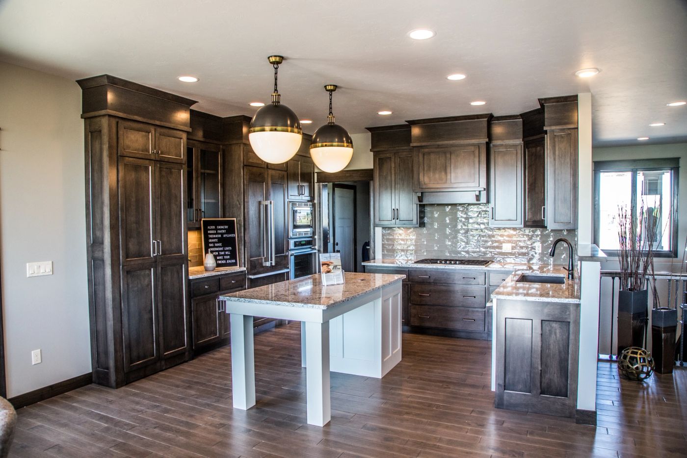 Kitchen island with seating and pendant lighting in a remodeled Sioux Falls home