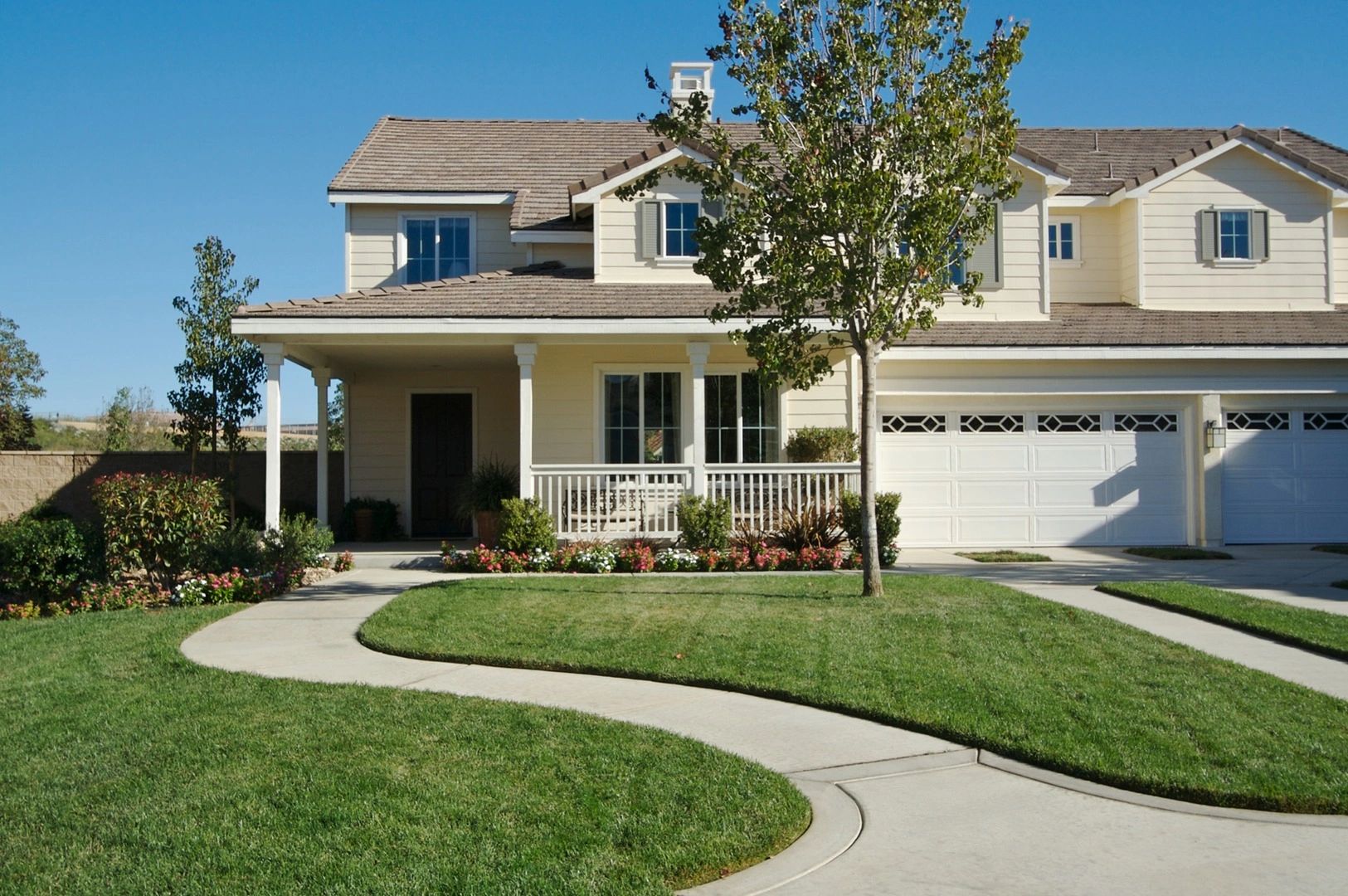 A two-story suburban house with a front porch and garage.