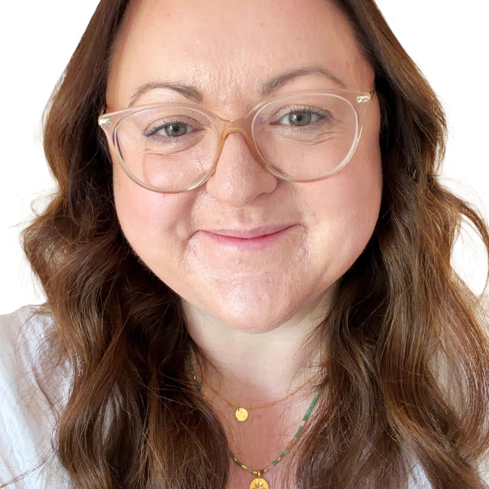 Close-up of a smiling woman with glasses.