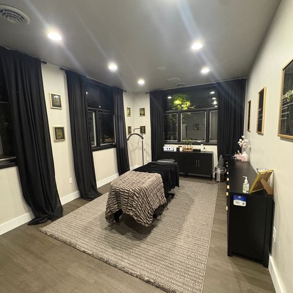 Clean and cozy treatment room with dim lighting.