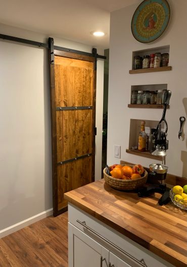 Rustic wooden sliding door in a kitchen.