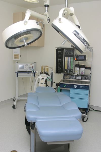 Reclining treatment chair and equipment.