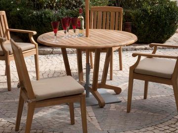 teak 4 chair and dining table with umbrella near pool
