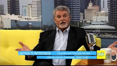 James S Wittmack speaking on a talk show set with yellow couch and city backdrop.