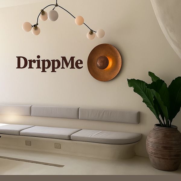 Minimalist interior with DrippMe sign, modern lighting, bench seating, and a large plant.
