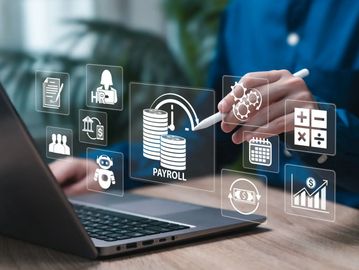 Person interacting with digital payroll and finance icons on laptop.