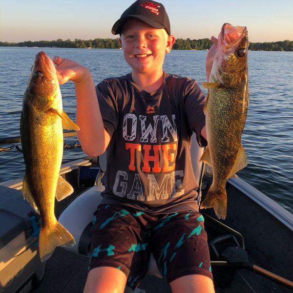 A young angler with two Minnesota State Fish