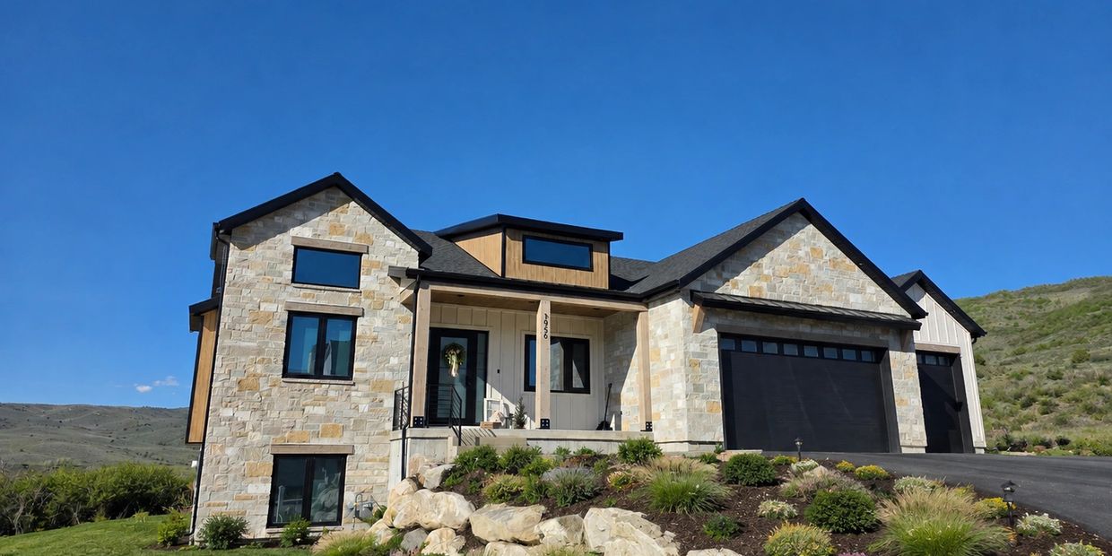 Exterior picture of a completed home with stone timber and wood siding.