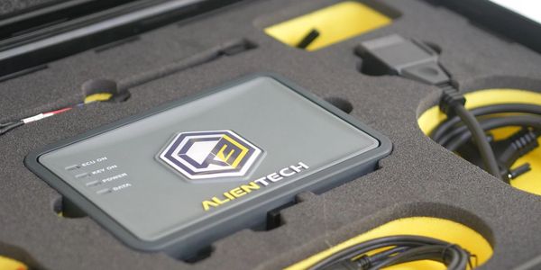 Alientech device and cables in a protective foam case.