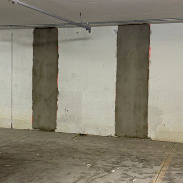 Two concrete cracks that have been treated and coated with waterproofing ready to be painted 
