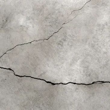 Cracked concrete surface with visible fractures.