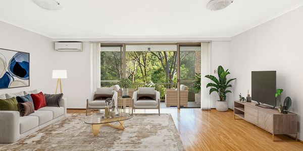 Bright living room with large windows and modern furnishings.