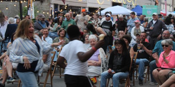 Crowd dancing in the street at an Ohio Valley street party — the kind of night Insiders hear about f