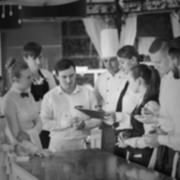 Team meeting in restaurant with front of house and back of house 