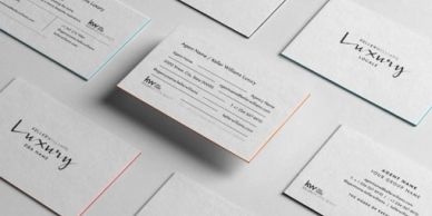 Minimalist luxury business cards with clean typography and subtle colored edges.