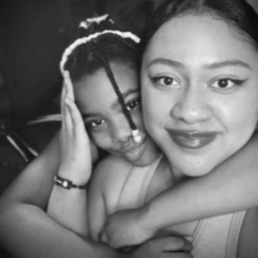 Two people sharing a close, affectionate hug in a black and white photo.