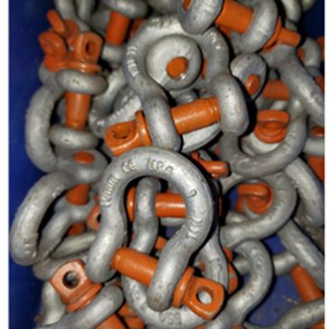 Pile of metal shackles with orange pins.