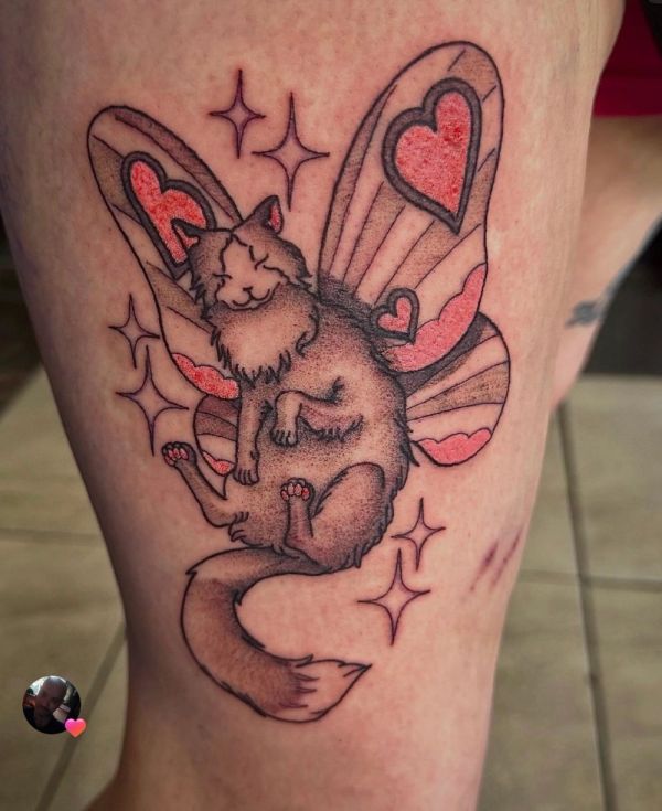 Tattoo of a cat with butterfly wings and hearts.