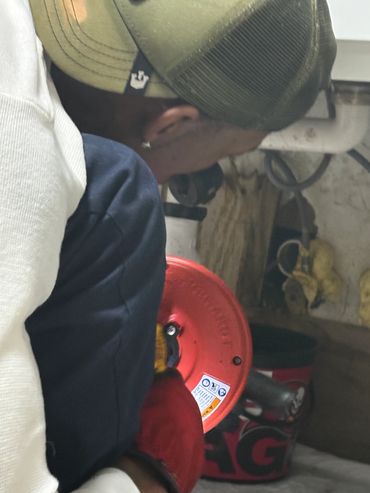 Mr. Wop Using the Auger to Service Under a Kitchen Sink with a Clog and Slow Drain