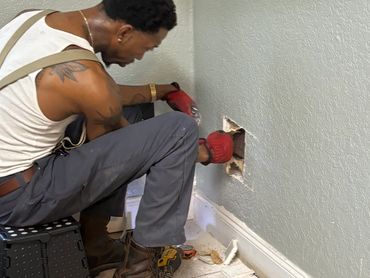 Mr. Wop Cutting into Wall to Access Shower Pipe Connections for Replacement 