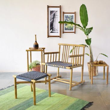 Minimalist bamboo furniture set with green accents and wall art.