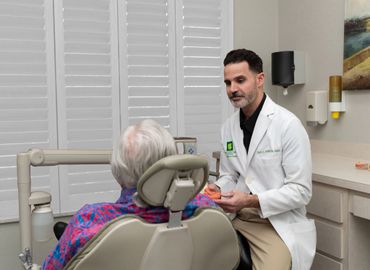 Doctor consulting with an elderly patient in a medical office.
