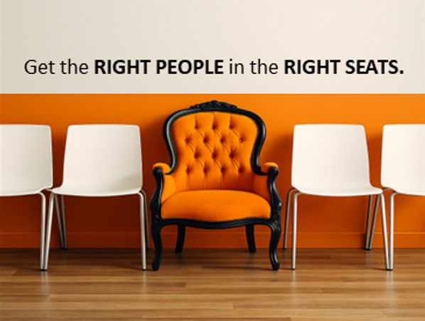 An orange armchair stands out among white chairs with a motivational quote above.