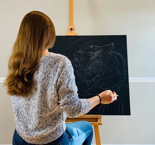 Artist painting on a easel 