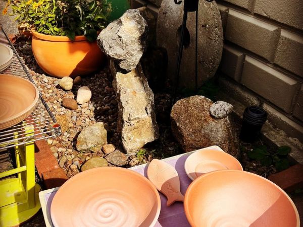 Clay pottery made at Artyard Studio drying in the sunshine in WNY.