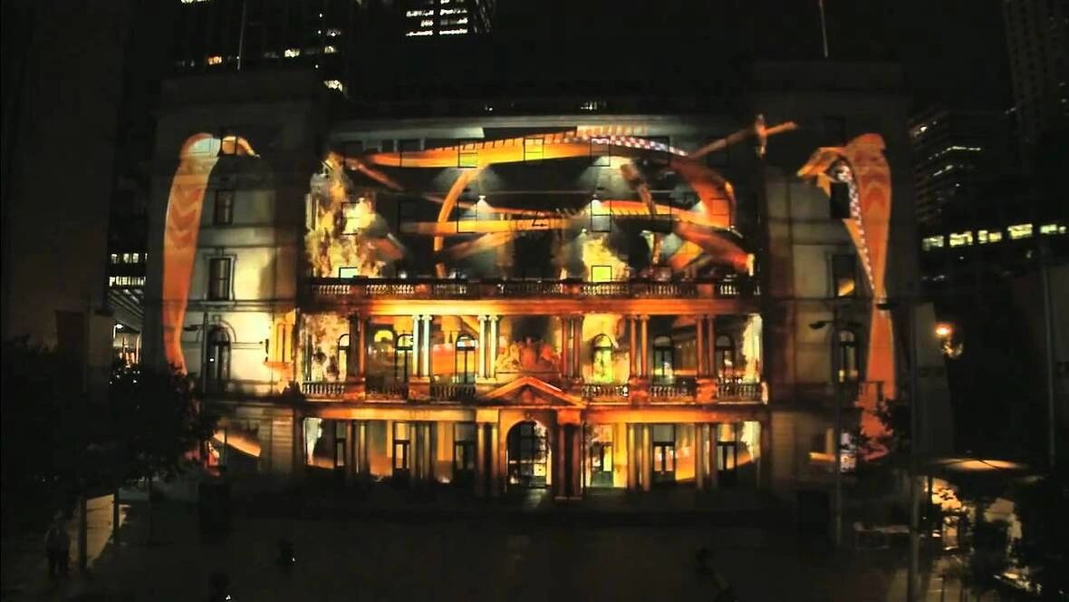Dynamic projection mapping on a historic building, showcasing vibrant animations and visuals, illustrating the innovative use of projection media in marketing and advertising.
