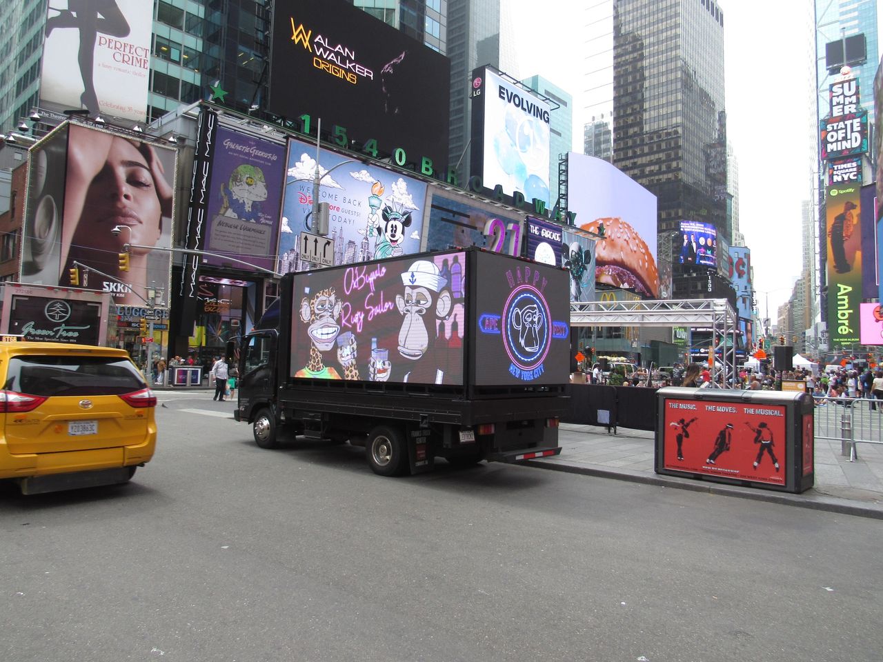 Truck with LED screen displaying vibrant advertisements in Times Square, New York City, featuring colorful graphics and branding elements, surrounded by bustling urban atmosphere and iconic billboards.