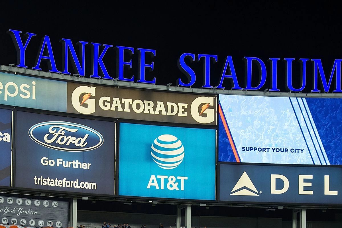 Yankee Stadium advertising display featuring prominent brand logos like Gatorade, Ford, AT&T, and Delta, showcasing the effectiveness of stadium advertising for brand visibility and audience engagement during sports events.