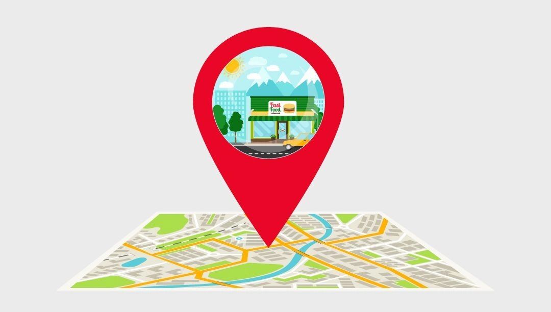Using geotagging technology is one method of tracking sidewalk stencils Geotagging illustration featuring a red location pin over a map, highlighting a fast food restaurant in an urban setting, symbolizing tracking for sidewalk stencil advertising campaigns.