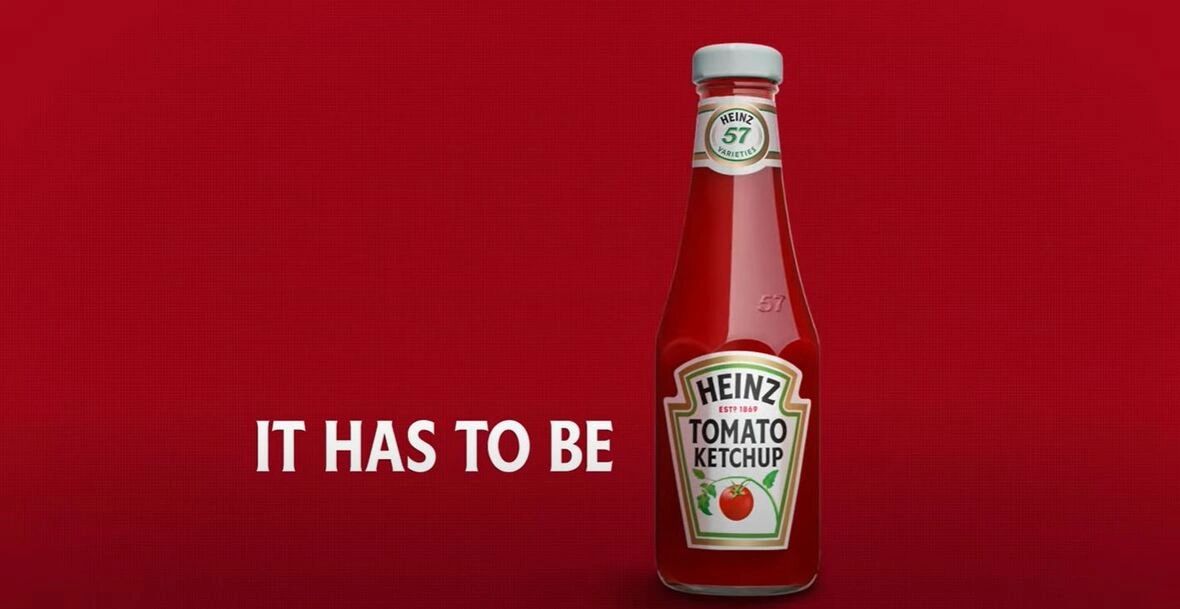 Heinz Tomato Ketchup bottle with "IT HAS TO BE" tagline on red background, representing AI-driven advertising creativity in marketing strategies.