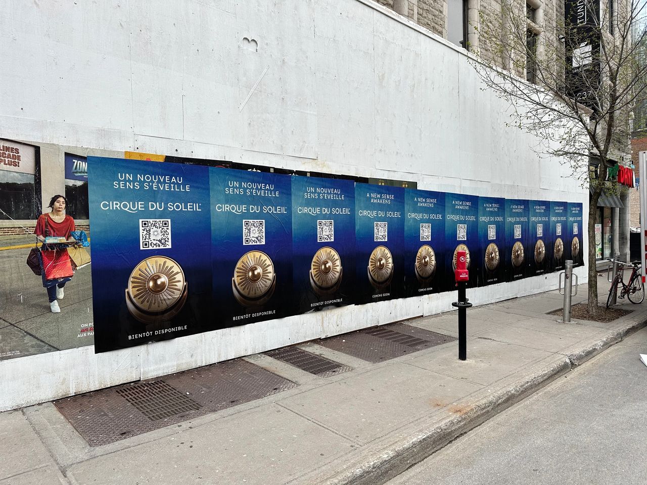 Wheatpasting posters for Cirque du Soleil displaying vibrant graphics and QR codes, enhancing Quebec City's urban landscape and promoting guerrilla marketing strategies.