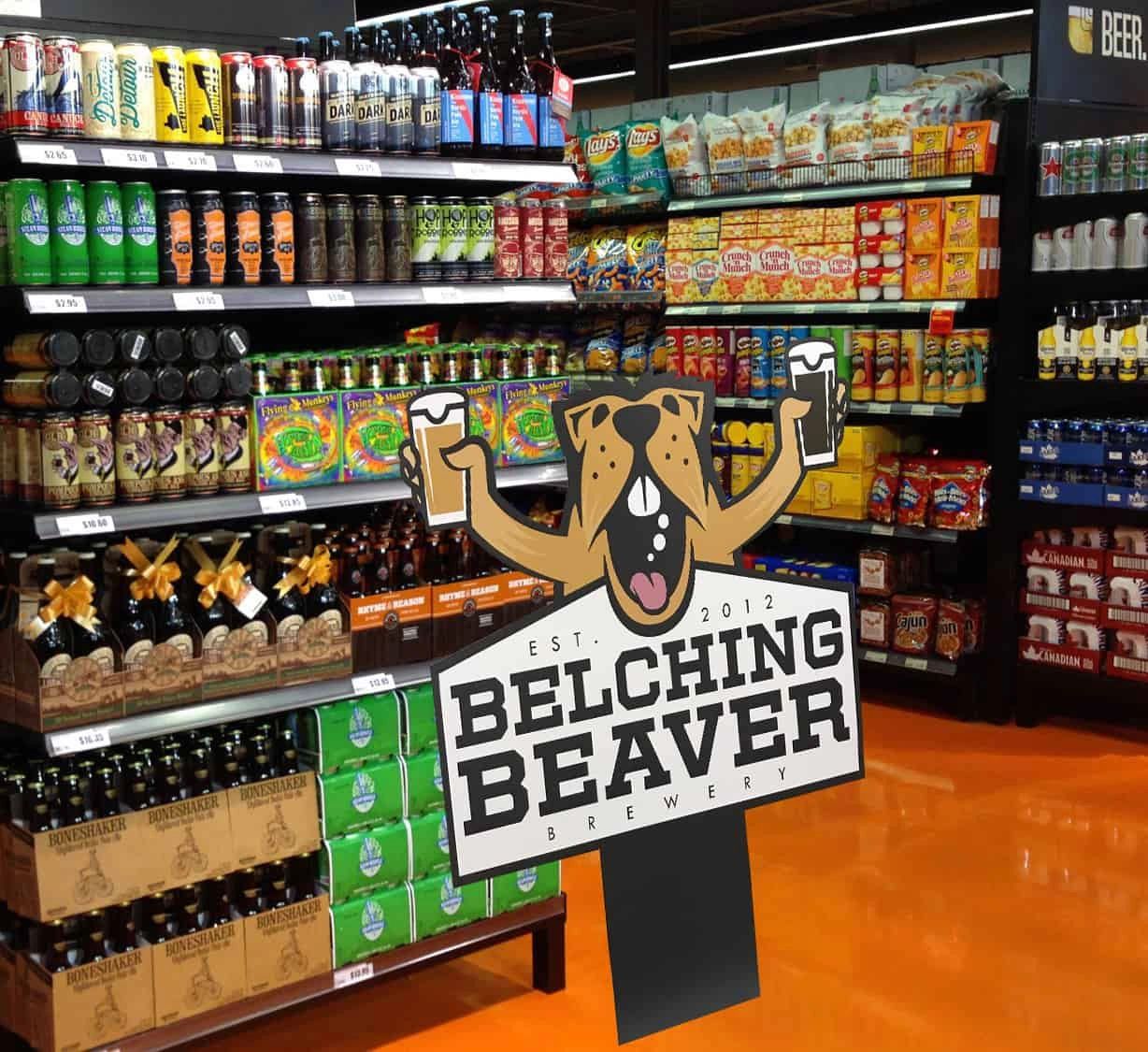 Beverage display featuring Belching Beaver Brewery products, including various beers and snacks, highlighting point of sale advertising strategies for increased customer engagement and impulse purchases.