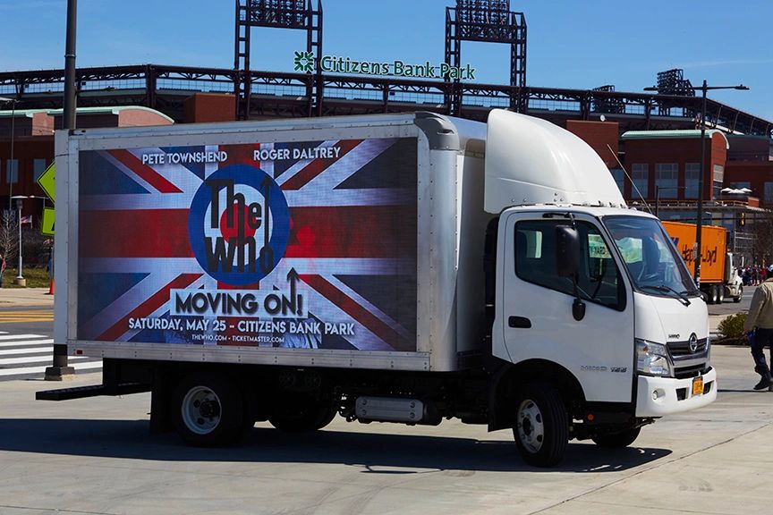 Philadelphia: Experimental Marketing with LED Billboard Trucks LED billboard truck promoting The Who concert with British flag design, featuring event details and location at Citizens Bank Park, Philadelphia.