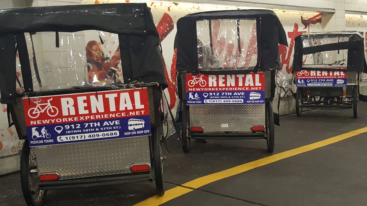 Pedicabs for rent with signage displaying "RENTAL" and contact information, highlighting eco-friendly transportation options in urban settings.