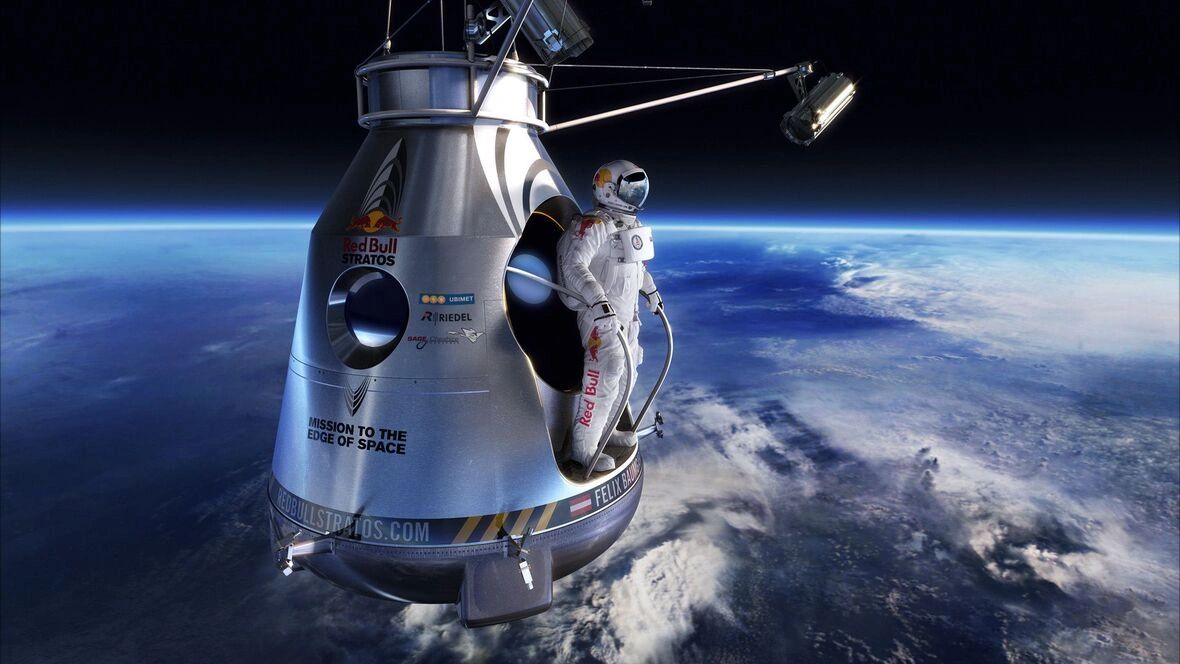 Austrian skydiver Felix Baumgartner in space capsule for Red Bull Stratos mission, showcasing extreme sports marketing and innovation.