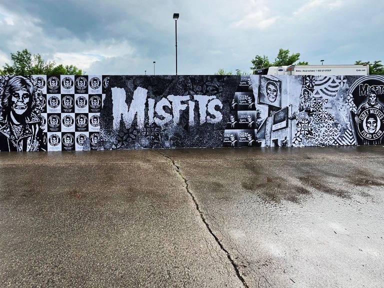 Mural featuring the word "MISFITS" and various artistic elements, emphasizing poster marketing's visual impact in Pennsylvania.
