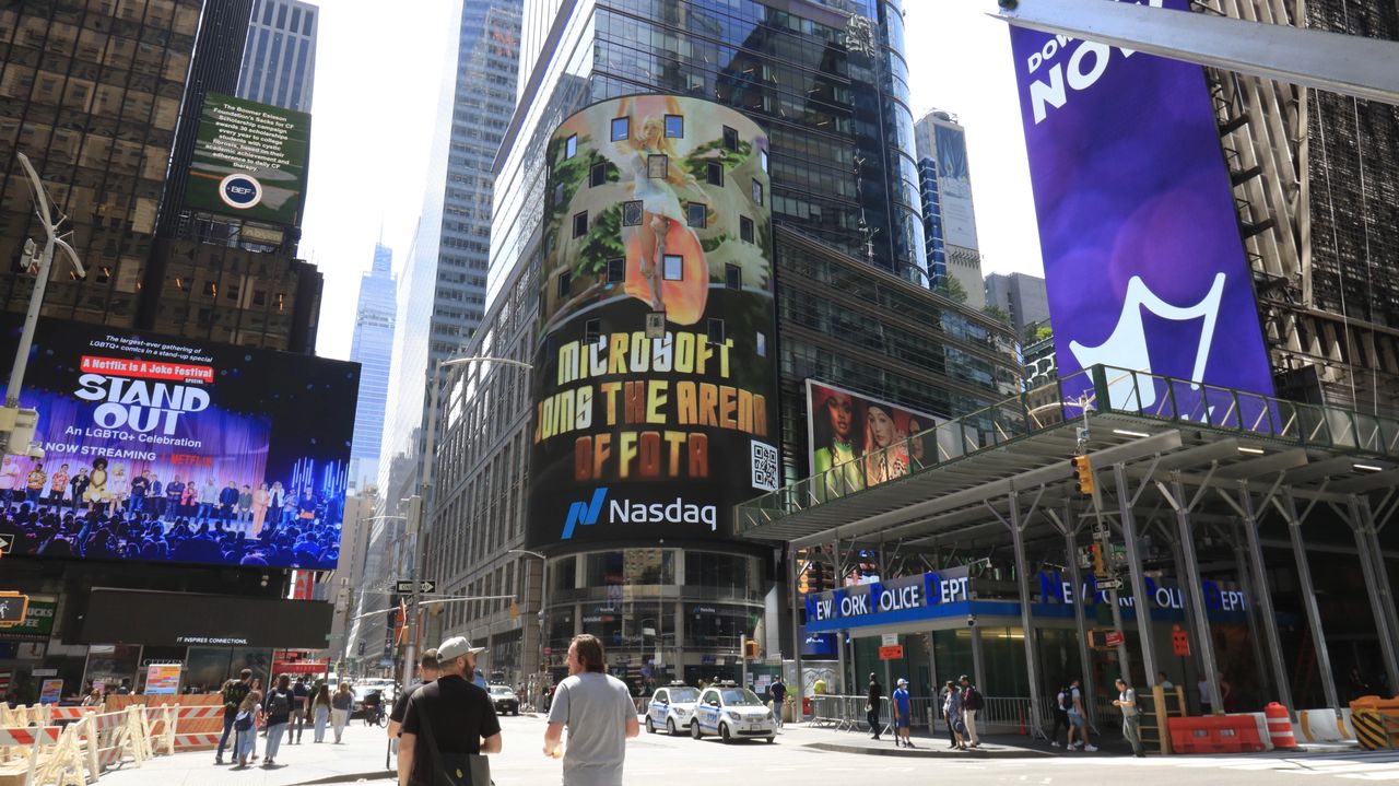 Billboards in Times Square featuring Microsoft advertisement and Netflix's "Stand Out" promotion, showcasing programmatic advertising in a vibrant urban setting.
