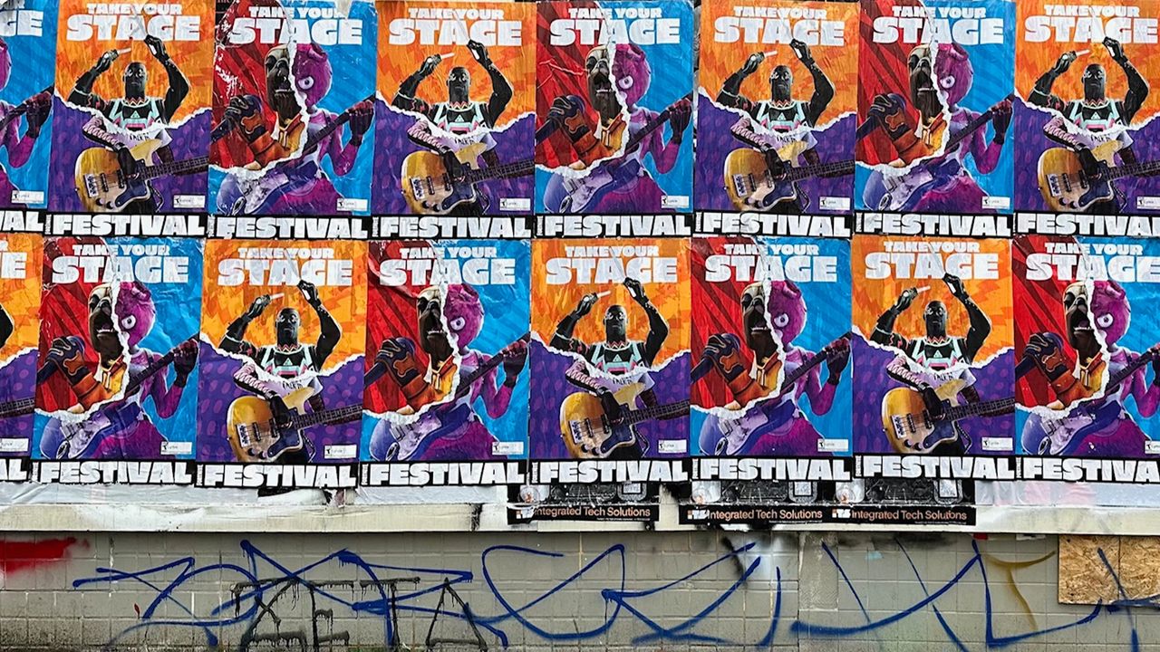 Wheatpaste posters featuring colorful designs promoting a music festival, showcasing vibrant graphics and the phrase "Take Your Stage," emphasizing urban street advertising techniques.