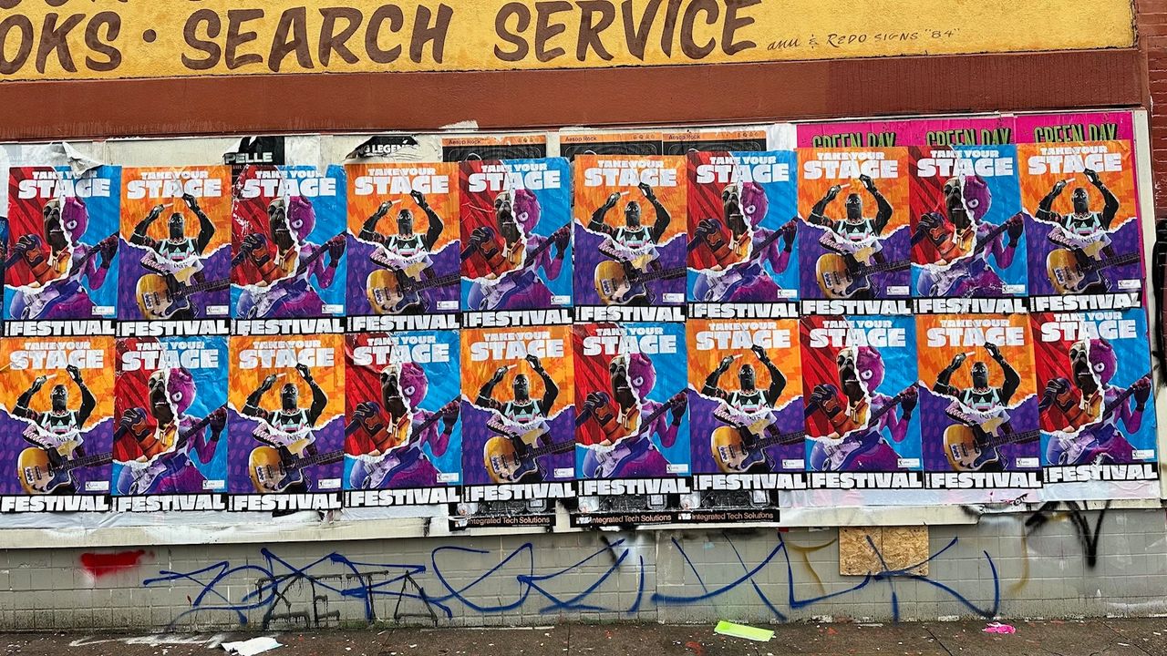 Colorful street posters promoting a music festival with the text "Take Your Stage" and vibrant graphics, showcasing a lively urban environment relevant to brand activation strategies in Nevada.