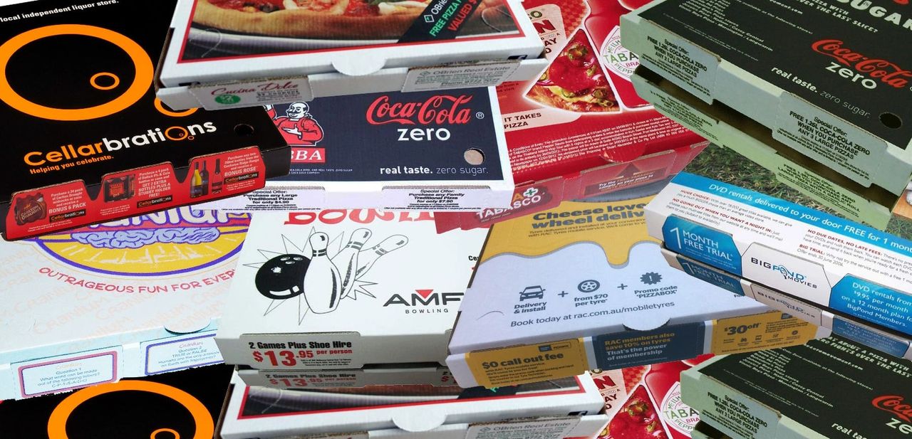 Pizza boxes featuring various advertisements, including promotions for Coca-Cola Zero, Cellarbrations, and AMF Bowling, illustrating the concept of pizza box advertising as a marketing strategy.