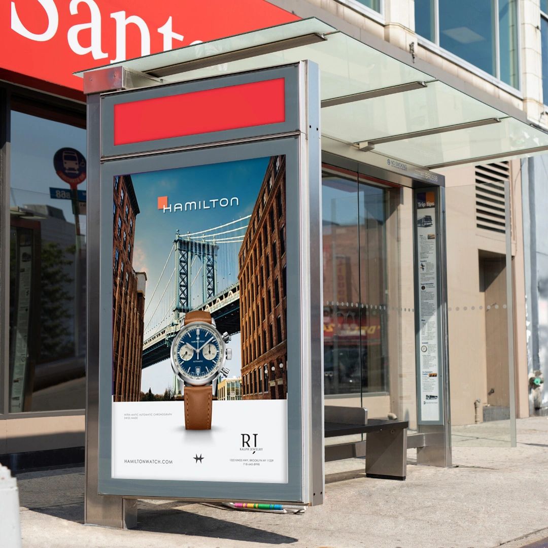 Bus shelter advertisement featuring Hamilton watch, showcasing Manhattan Bridge backdrop, emphasizing high visibility and brand engagement for effective outdoor marketing.