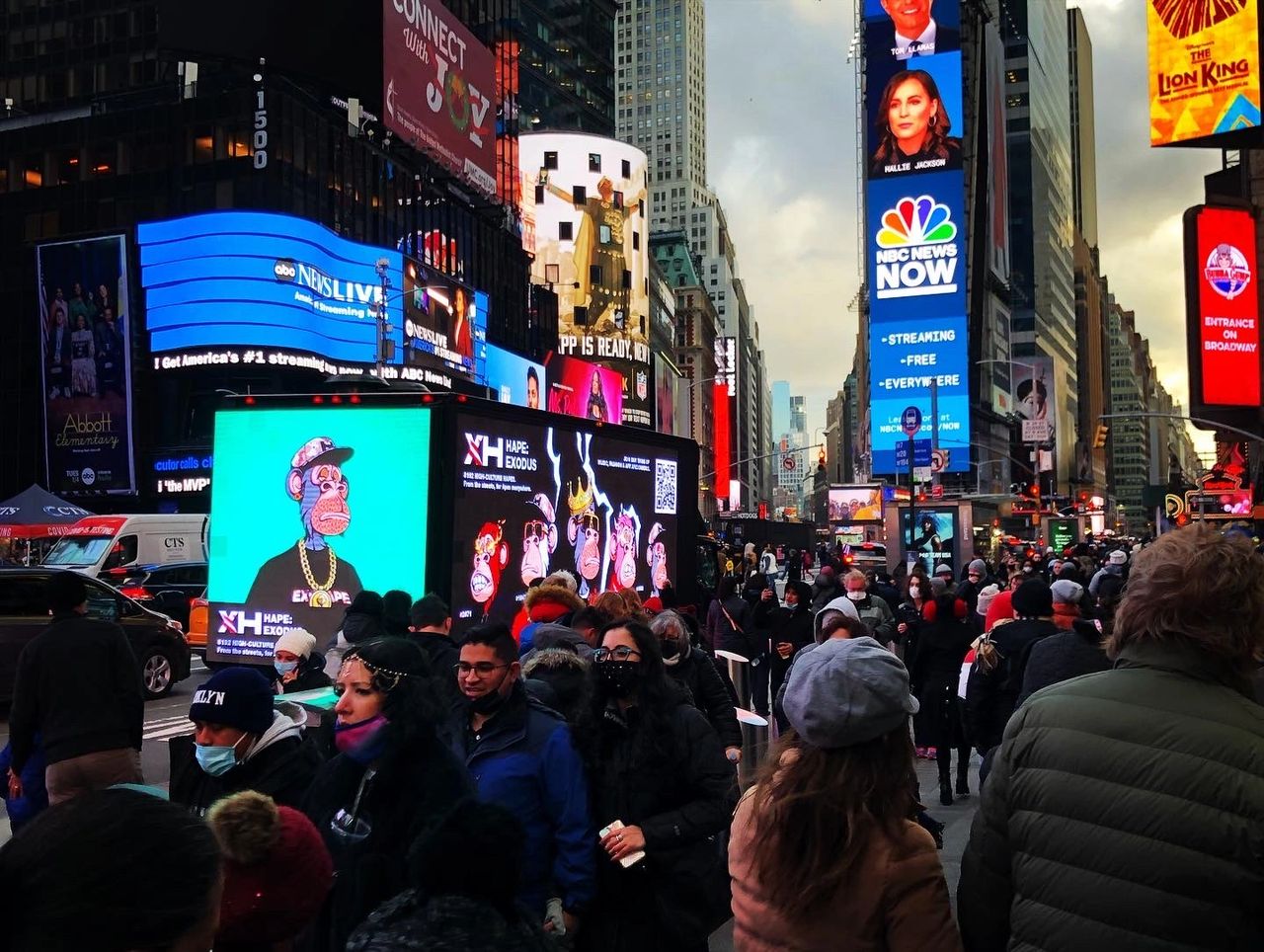 LED mobile billboard truck featuring vibrant animated characters in Times Square, surrounded by a bustling crowd and iconic NYC advertisements.