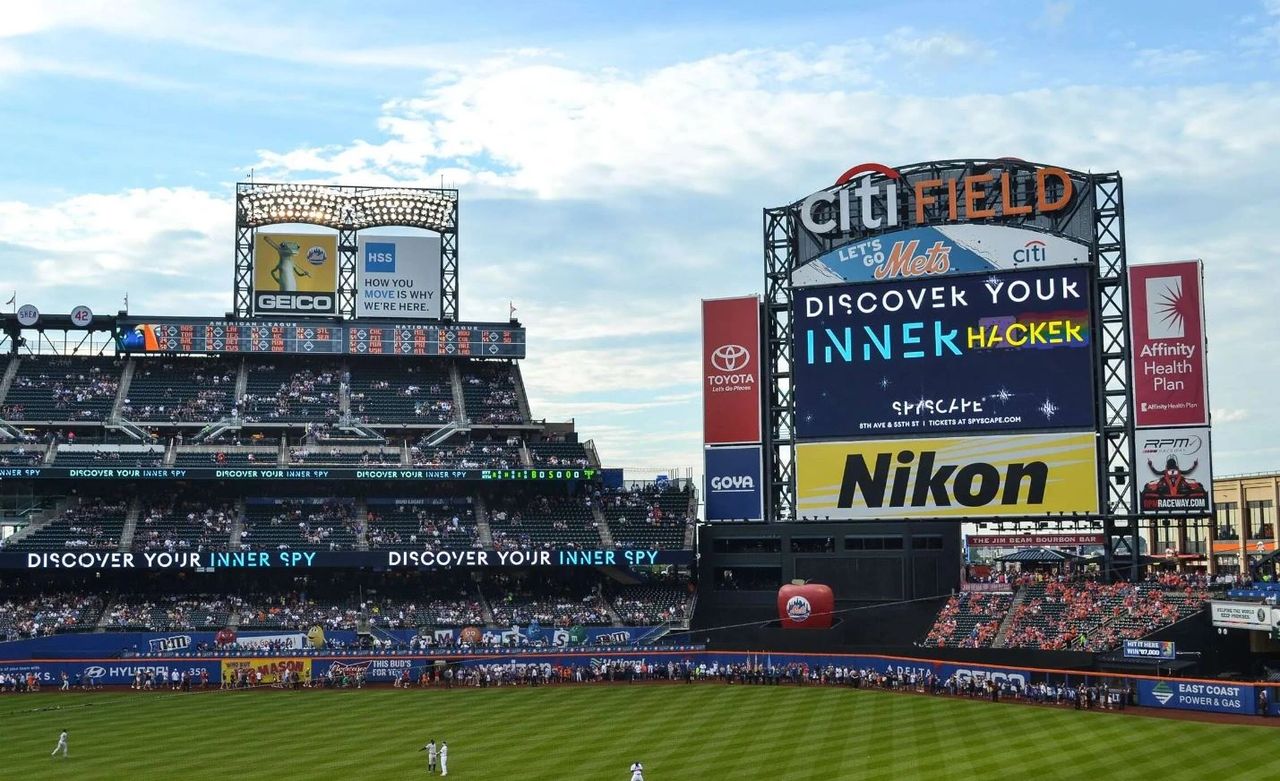 Citi Field stadium advertising featuring various brand displays including Geico, Nikon, and HSS, showcasing the potential of stadium advertising for enhancing brand visibility and engaging a captive audience.