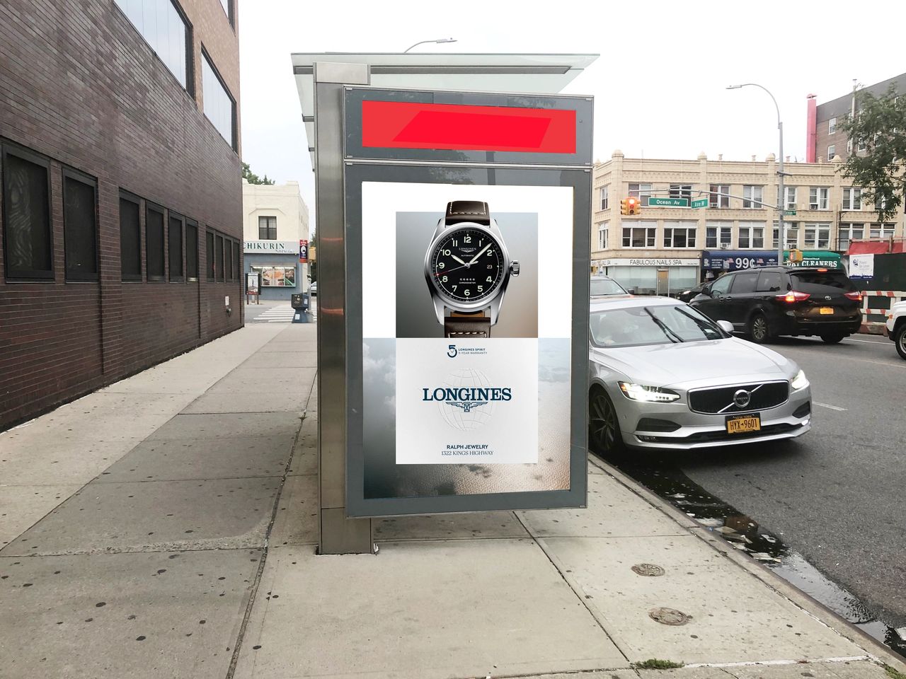 Bus shelter advertisement featuring a Longines watch, showcasing the brand's logo and a promotional message, positioned on a city sidewalk with vehicles and buildings in the background.
